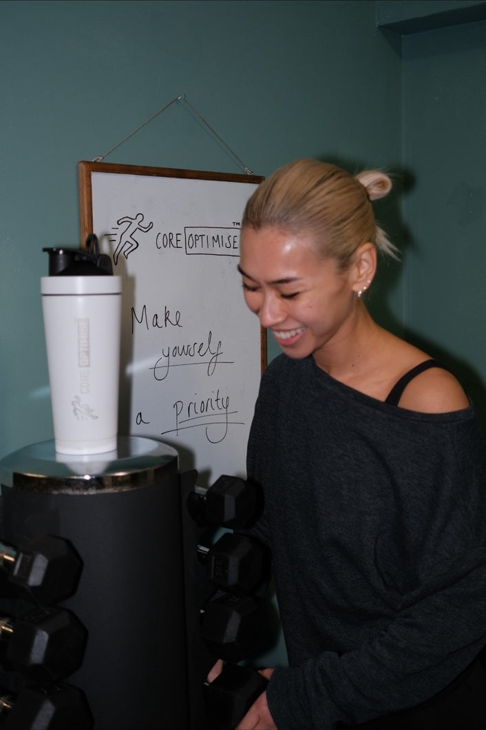 Woman in home gym representing CoreFoundation daily health-conscious routines